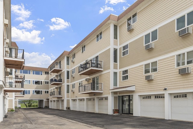 407 Ocean Blvd Unit A11, Hampton, NH 03842 - view of apartment building / complex with driveway, a garage, and cooling unit