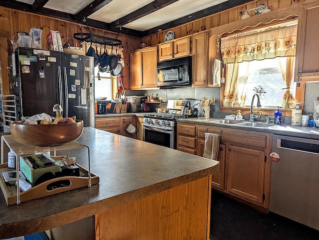 5559 W Creek Rd, Brandon, VT 05733 - kitchen with black appliances, wooden walls, beamed ceiling, brown cabinets, and dark countertops