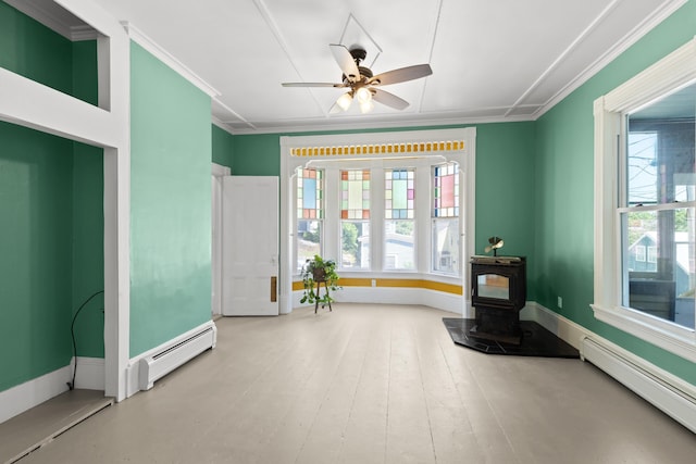 10 Prospect St, Somersworth, NH 03878 - living area featuring baseboard heating, a wood stove, a ceiling fan, and crown molding