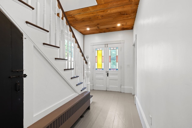 10 Prospect St, Somersworth, NH 03878 - foyer with stairway, wood ceiling, radiator, and light wood-style flooring