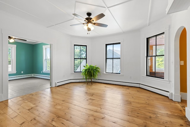 10 Prospect St, Somersworth, NH 03878 - spare room featuring a ceiling fan, arched walkways, light wood-style flooring, a baseboard heating unit, and crown molding