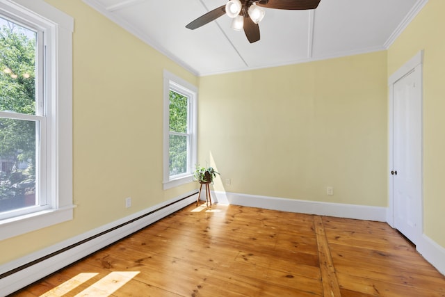 10 Prospect St, Somersworth, NH 03878 - empty room featuring a baseboard radiator, a ceiling fan, light wood-style flooring, crown molding, and attic access