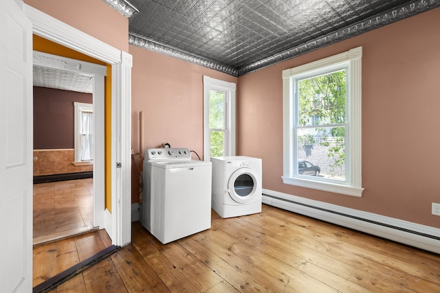 10 Prospect St, Somersworth, NH 03878 - washroom with separate washer and dryer, a baseboard heating unit, hardwood / wood-style floors, and an ornate ceiling