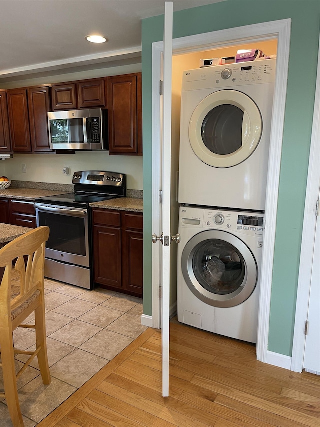 207 Long Pond Rd, Danville, NH 03819 - laundry area with estacked washer and dryer, light wood-style flooring, and recessed lighting
