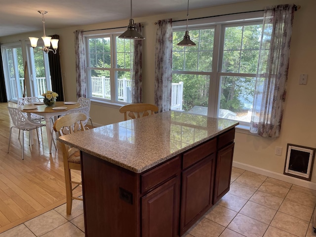 207 Long Pond Rd, Danville, NH 03819 - kitchen with a chandelier, light tile patterned flooring, plenty of natural light, and pendant lighting