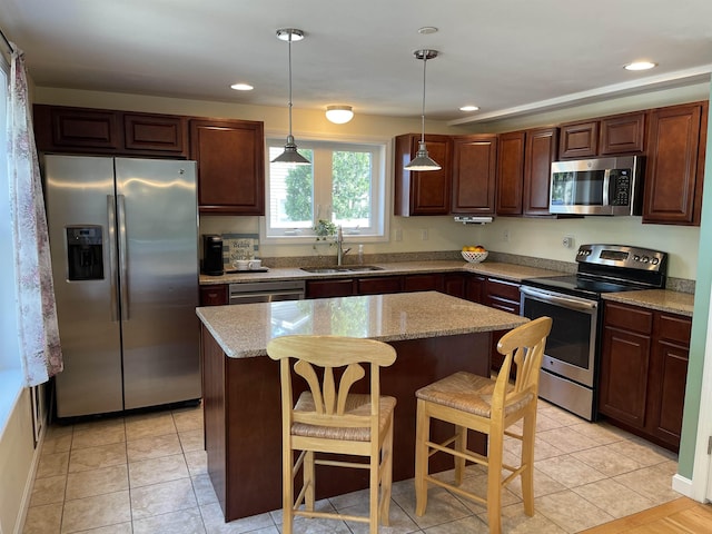 207 Long Pond Rd, Danville, NH 03819 - kitchen with stainless steel appliances, a center island, hanging light fixtures, a kitchen breakfast bar, and light stone countertops