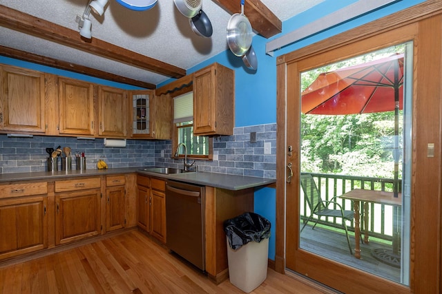 4B Pine Isle Dr Unit B, Derry, NH 03038 - kitchen featuring stainless steel dishwasher, beam ceiling, tasteful backsplash, brown cabinets, and a textured ceiling