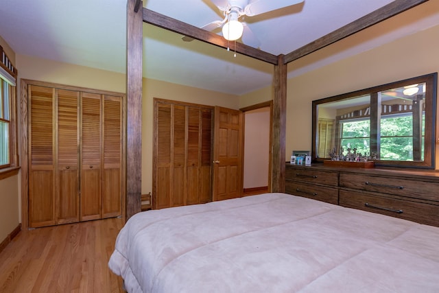 4B Pine Isle Dr Unit B, Derry, NH 03038 - bedroom with light wood-type flooring, multiple closets, and a ceiling fan