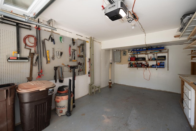 4B Pine Isle Dr Unit B, Derry, NH 03038 - garage featuring a garage door opener, a workshop area, and electric panel