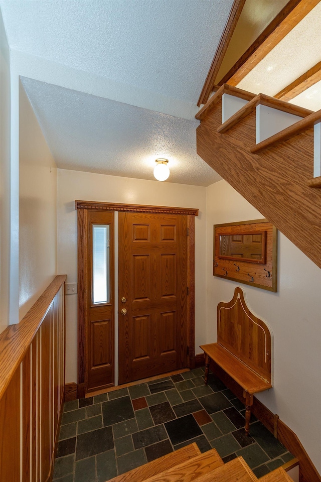 4B Pine Isle Dr Unit B, Derry, NH 03038 - foyer entrance with a textured ceiling, dark stone finish flooring, and stairway