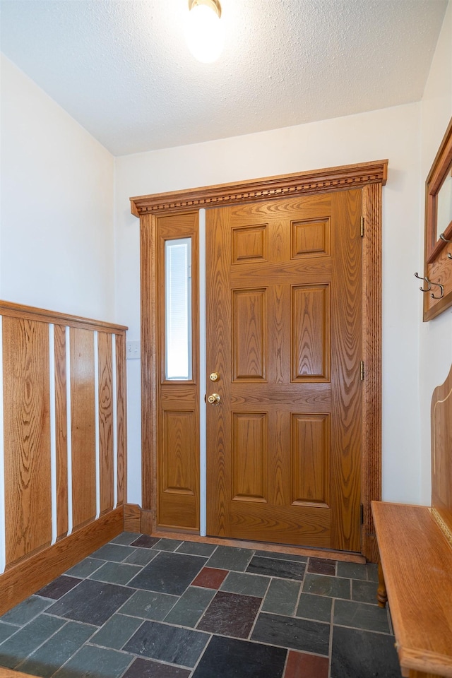 4B Pine Isle Dr Unit B, Derry, NH 03038 - foyer entrance with stone tile floors and a textured ceiling