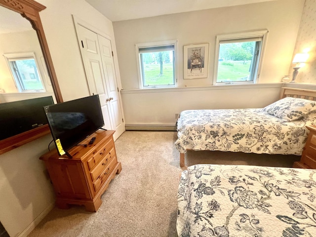8B Deer Crk, Dover, VT 05356 - carpeted bedroom featuring a baseboard radiator and a closet