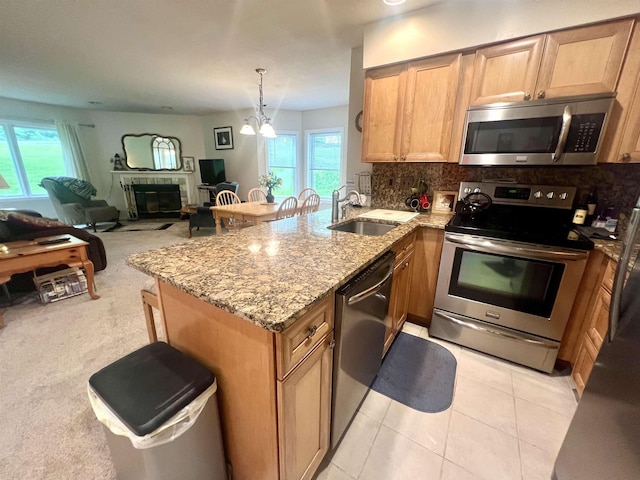 8B Deer Crk, Dover, VT 05356 - kitchen with stainless steel appliances, a peninsula, plenty of natural light, and decorative backsplash