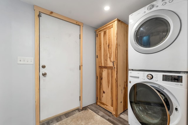 16 Damsite Rd, Barnstead, NH 03225 - washroom with stacked washer / dryer, light wood-style floors, and cabinet space