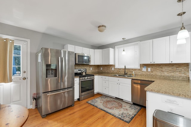 16 Damsite Rd, Barnstead, NH 03225 - kitchen featuring stainless steel appliances, light wood-style floors, tasteful backsplash, and white cabinets