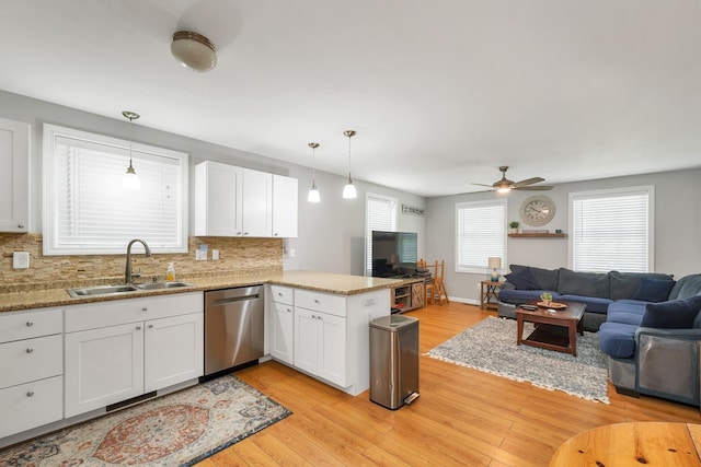 16 Damsite Rd, Barnstead, NH 03225 - kitchen with stainless steel dishwasher, open floor plan, decorative backsplash, and white cabinetry