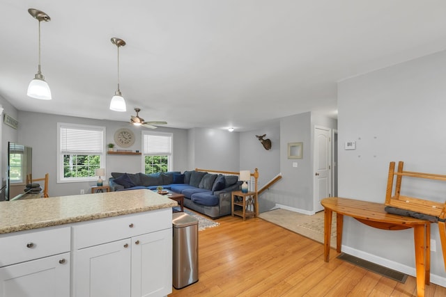 16 Damsite Rd, Barnstead, NH 03225 - kitchen featuring light wood-style flooring, white cabinets, pendant lighting, open floor plan, and ceiling fan