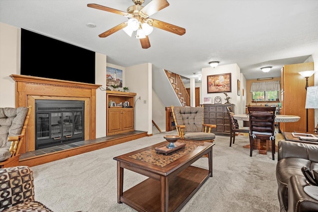 79 Dunvegan Woods Dr Unit 79, Hampton, NH 03842 - living room featuring carpet floors, stairs, ceiling fan, and a glass covered fireplace