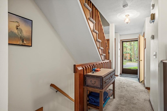 79 Dunvegan Woods Dr Unit 79, Hampton, NH 03842 - corridor with a textured ceiling, carpet flooring, and an upstairs landing