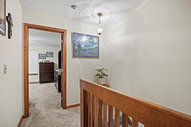 79 Dunvegan Woods Dr Unit 79, Hampton, NH 03842 - hallway featuring light carpet and a textured ceiling