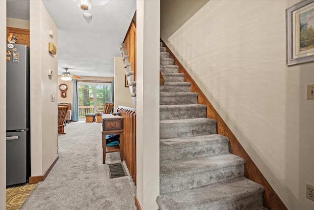 79 Dunvegan Woods Dr Unit 79, Hampton, NH 03842 - staircase with carpet flooring, a textured ceiling, and ceiling fan