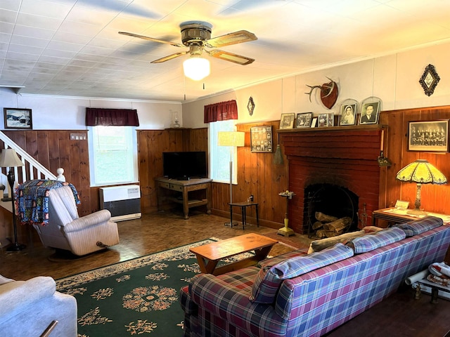 1056 Point Of Pines Rd, Castleton, VT 05735 - living area featuring wood walls, a brick fireplace, ceiling fan, wainscoting, and wood finished floors