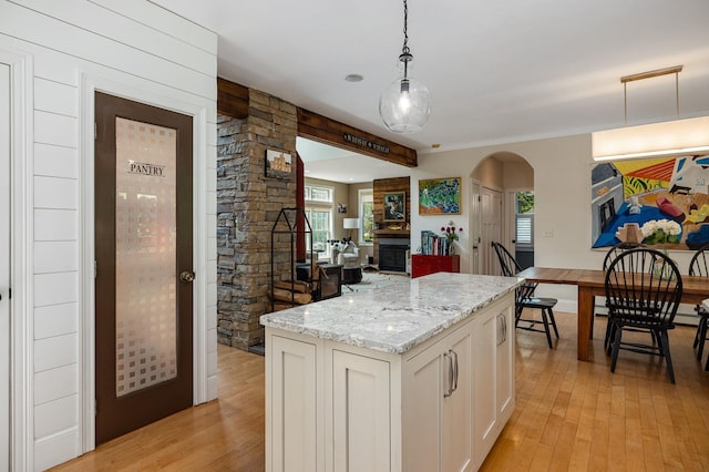 201 Walker Bungalow Rd, Portsmouth, NH 03801 - kitchen with light wood-style floors, arched walkways, and decorative light fixtures