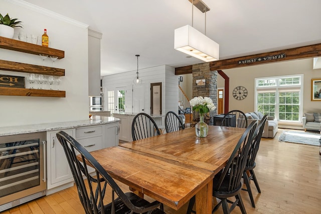 201 Walker Bungalow Rd, Portsmouth, NH 03801 - dining space featuring beverage cooler, light wood finished floors, and crown molding