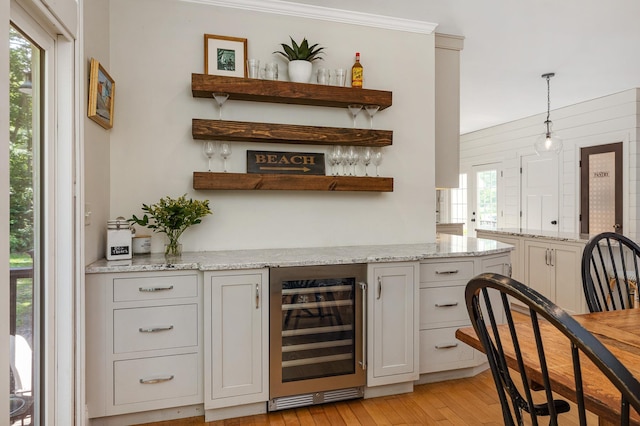 201 Walker Bungalow Rd, Portsmouth, NH 03801 - indoor dry bar with wine cooler, light wood-style flooring, and pendant lighting