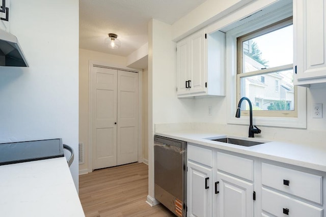 129 Fisherville Rd Unit 26, Concord, NH 03303 - kitchen featuring dishwasher, white cabinetry, light countertops, and light wood-type flooring