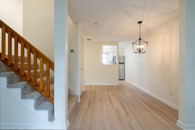 129 Fisherville Rd Unit 26, Concord, NH 03303 - foyer entrance featuring light wood finished floors, stairs, and a chandelier