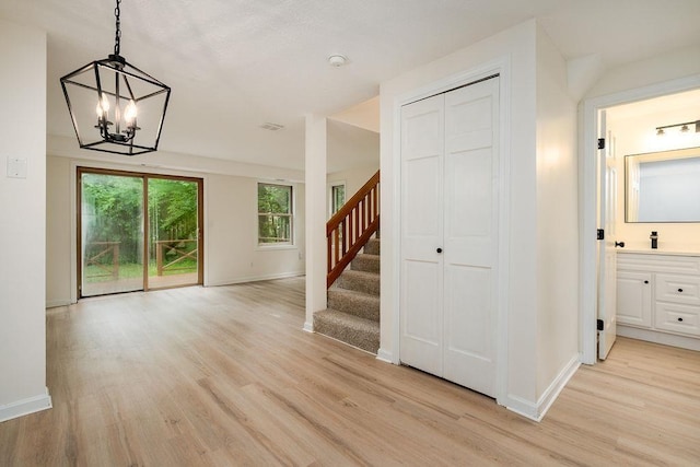 129 Fisherville Rd Unit 26, Concord, NH 03303 - interior space with stairway, a chandelier, and light wood-style flooring