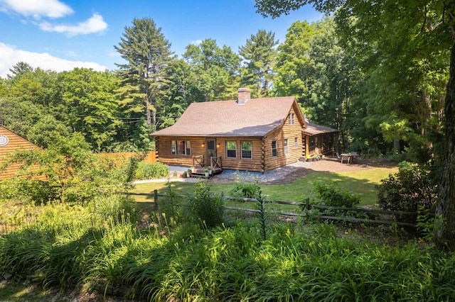 30 W Rd, Hubbardton, VT 05743 - back of property with log exterior, a chimney, and a wooded view