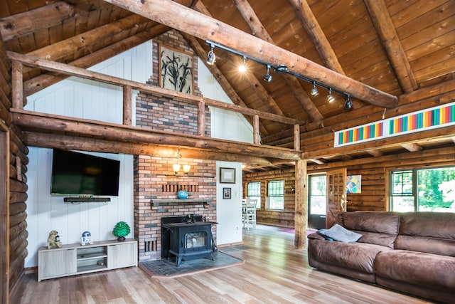 30 W Rd, Hubbardton, VT 05743 - living area with rail lighting, a wooden ceiling with exposed beams, high vaulted ceiling, wood finished floors, and a wood stove