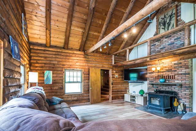 30 W Rd, Hubbardton, VT 05743 - living room featuring a wooden ceiling with exposed beams, high vaulted ceiling, wood finished floors, log walls, and a wood stove