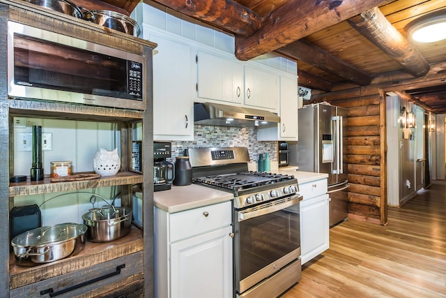30 W Rd, Hubbardton, VT 05743 - kitchen featuring log walls, under cabinet range hood, stainless steel appliances, a wood ceiling with exposed beams, and light countertops