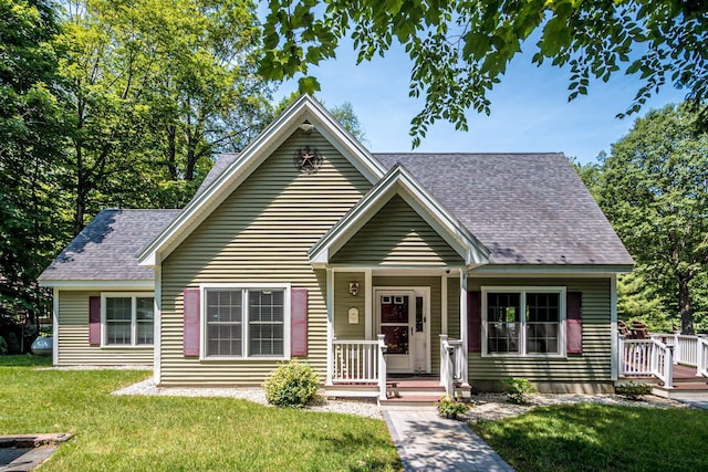 11 Captain Lovewell Ln, Ossipee, NH 03814 - view of front of house featuring roof with shingles and a front lawn