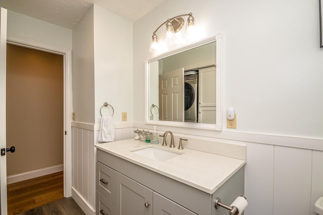 11 Captain Lovewell Ln, Ossipee, NH 03814 - bathroom with vanity, wainscoting, wood finished floors, and a decorative wall