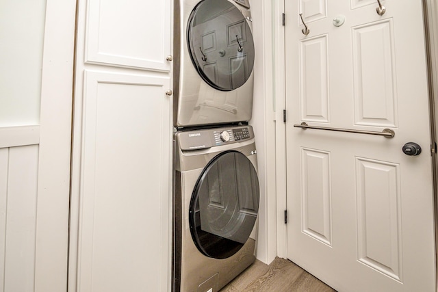 11 Captain Lovewell Ln, Ossipee, NH 03814 - washroom with stacked washer / dryer, cabinet space, and light wood-type flooring
