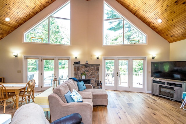 11 Captain Lovewell Ln, Ossipee, NH 03814 - living area featuring french doors, a stone fireplace, high vaulted ceiling, wooden ceiling, and light wood-type flooring