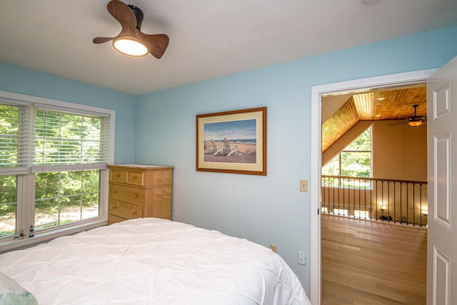 11 Captain Lovewell Ln, Ossipee, NH 03814 - bedroom featuring multiple windows, wood finished floors, and ceiling fan