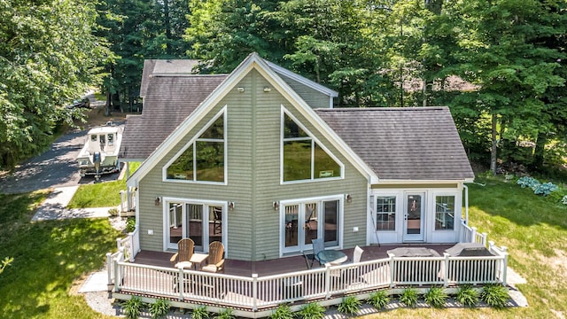 11 Captain Lovewell Ln, Ossipee, NH 03814 - back of property featuring french doors, a deck, roof with shingles, and a yard