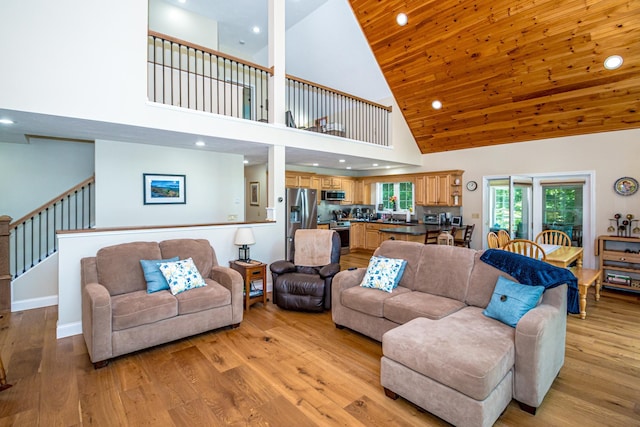 11 Captain Lovewell Ln, Ossipee, NH 03814 - living area with high vaulted ceiling, light wood finished floors, recessed lighting, and stairs