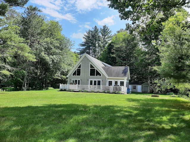 11 Captain Lovewell Ln, Ossipee, NH 03814 - rear view of house with a shed, a wooden deck, and a lawn