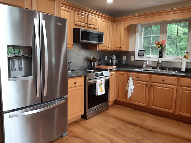 11 Captain Lovewell Ln, Ossipee, NH 03814 - kitchen featuring stainless steel appliances, light wood finished floors, dark countertops, tasteful backsplash, and recessed lighting