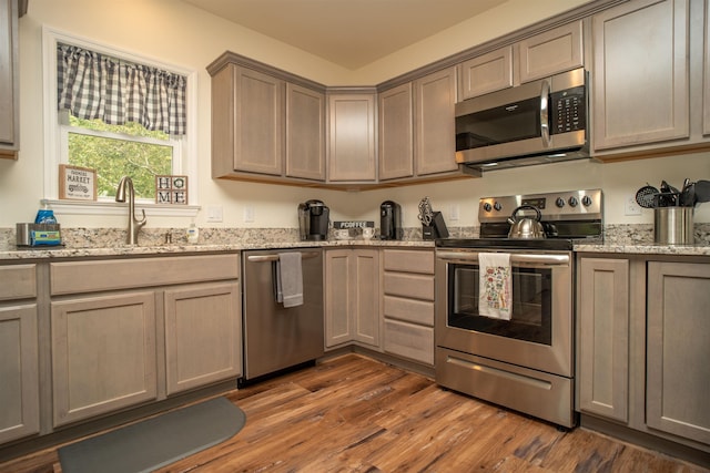 12 Encore Pl, Dover, VT 05356 - kitchen with stainless steel appliances, wood finished floors, and light stone counters