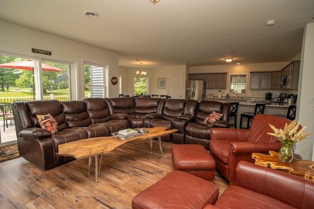 12 Encore Pl, Dover, VT 05356 - living room featuring light wood finished floors, a chandelier, and plenty of natural light