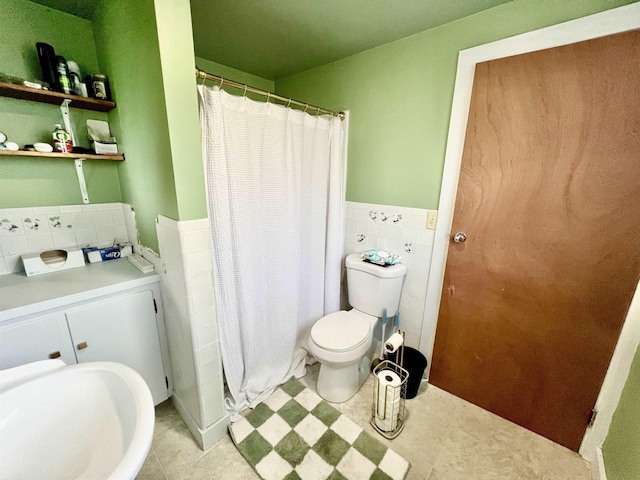 21 Main St, Rockingham, VT 05154 - full bath featuring a wainscoted wall, tile walls, and a shower with shower curtain
