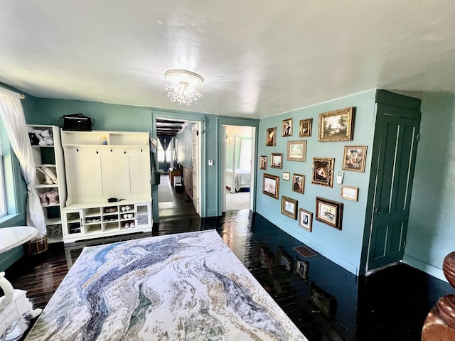 21 Main St, Rockingham, VT 05154 - bedroom with dark wood-style flooring and a chandelier