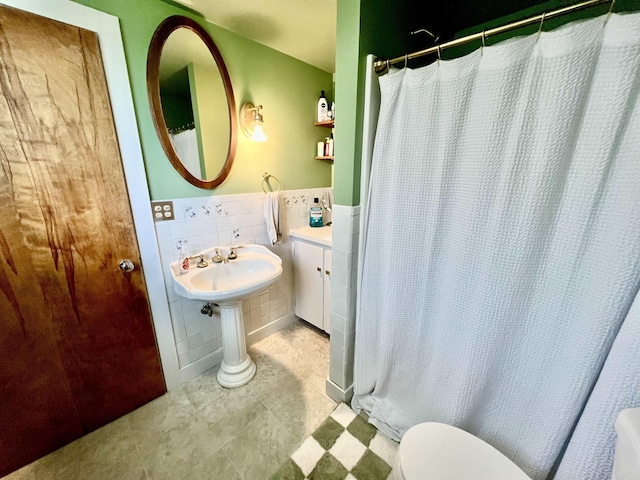 21 Main St, Rockingham, VT 05154 - full bathroom featuring tile walls, tile patterned floors, a wainscoted wall, and a shower with shower curtain